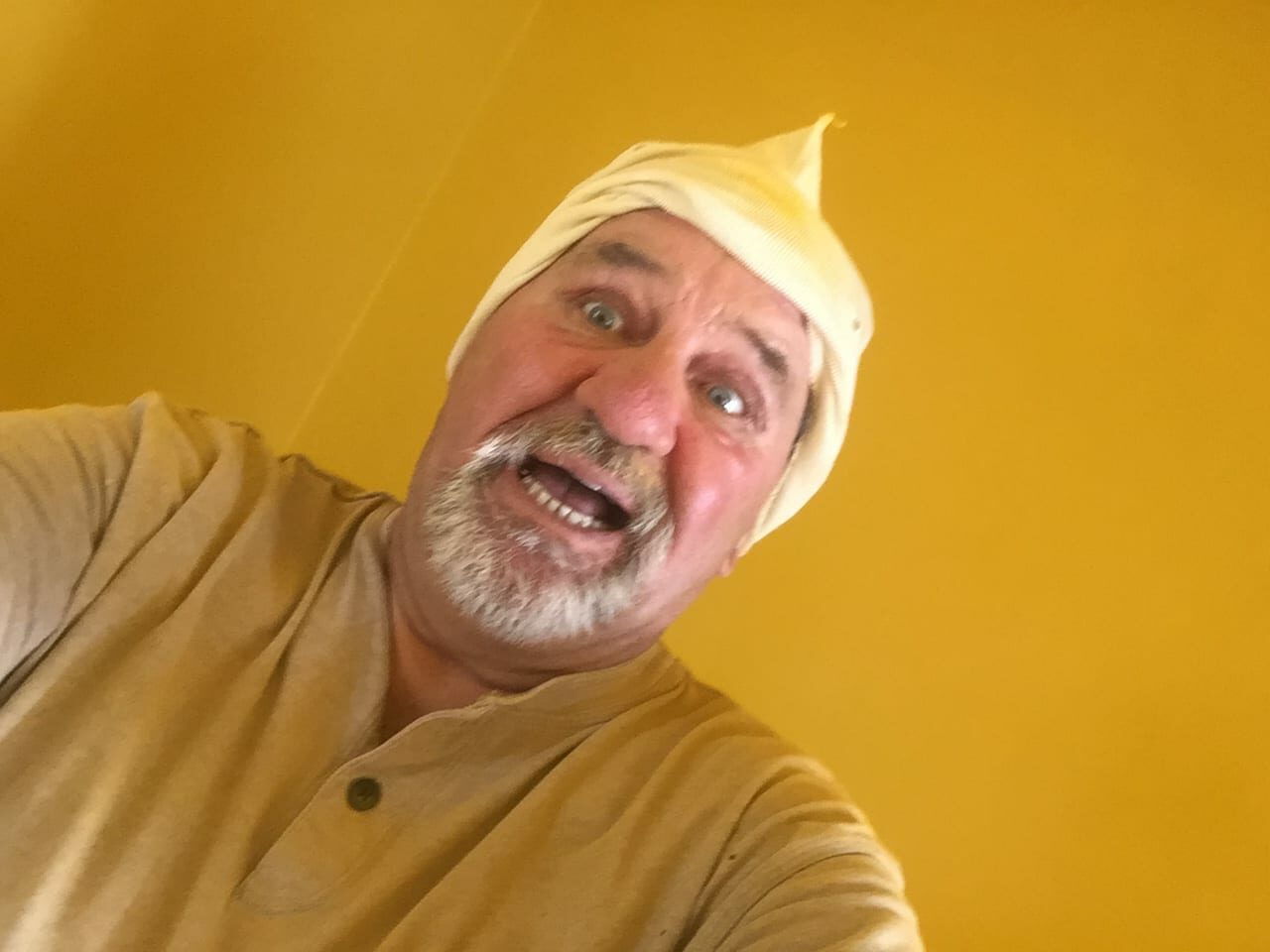 selfie of a man in a yellow shirt
